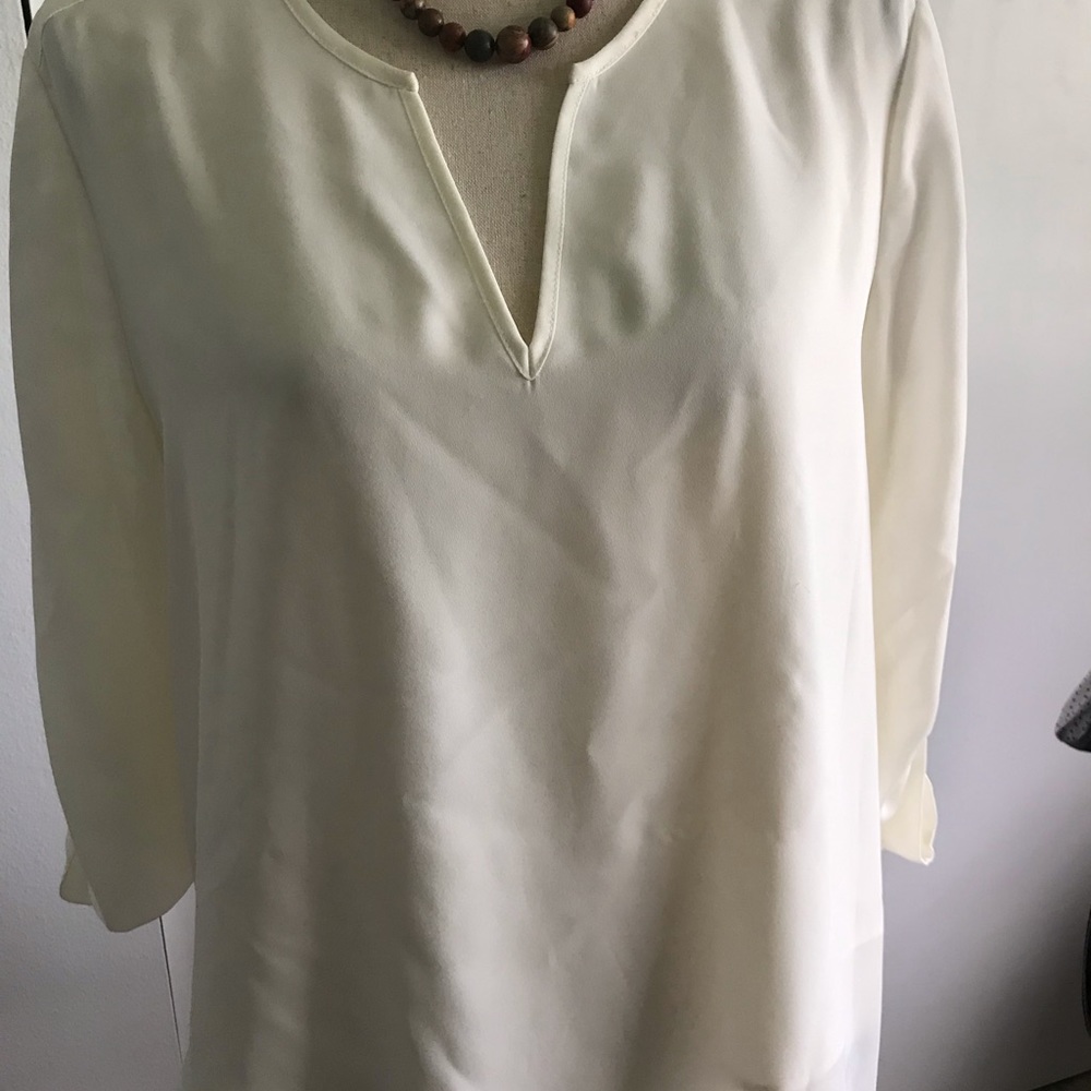 Pretty almond blouse with cute asymmetrical hem. M